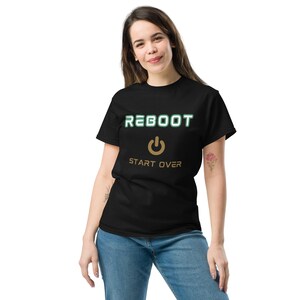 May include: Black t-shirt with a green and white "REBOOT" graphic and a gold power button symbol with the text "START OVER" underneath.