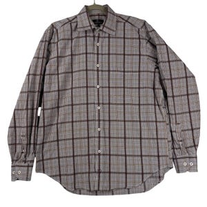 May include: A long-sleeve button-down shirt featuring a plaid pattern in shades of grey, dark maroon, and thin tan lines. The shirt has a standard collar, a front button placket with white buttons, and buttoned cuffs on each long sleeve.