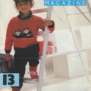 May include: A magazine cover featuring a child wearing a red sweater with panda bear designs, black pants, and red shoes. The magazine title is "The Bond Magazine". The cover also includes the number "13" and text about the issue.