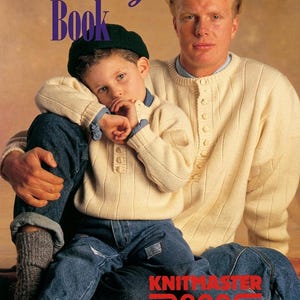 May include: Two cream-coloured, long-sleeved, button-front knit jumpers with vertical ribbed patterns. The text "The Mens & Boys Book" appears at the top, and "KNITMASTER creativeKONE 4PLY ANETO BLACKJACK" is printed at the bottom of the image.