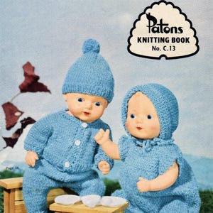 May include: A vintage knitting book cover titled DOLLS' CLOTHES FOR SIZES 10 to 22 inch DOLLS, featuring two dolls wearing blue knitted outfits. One doll wears a blue hat and buttoned suit, while the other wears a blue bonnet and dress.