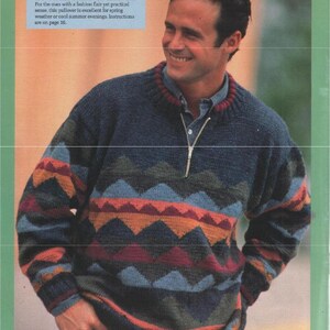 May include: A navy blue pullover with a geometric pattern in shades of blue, orange, and burgundy. The sweater has a zipper at the neckline and is worn by a person. The text in the image reads "10 MUTED PALETTE PULLOVER."
