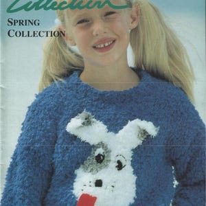 May include: A blue knit sweater with a dog face design. The sweater has a textured appearance and features a white dog face with black and gray accents and a red tongue. The image also includes text that reads "BOND Collection" and "SPRING COLLECTION".