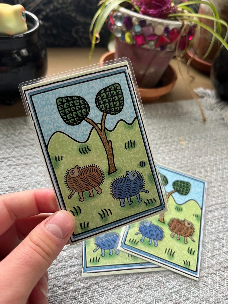 hand holding medieval themed laminated card