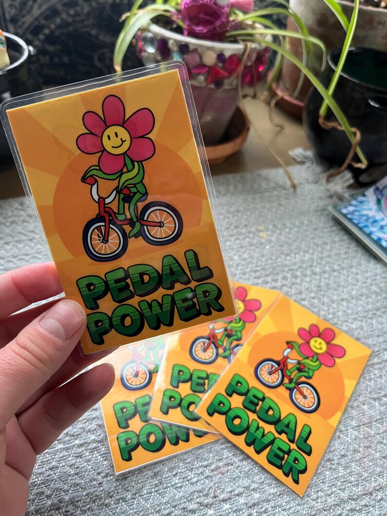 hand holding laminated card with riding bike