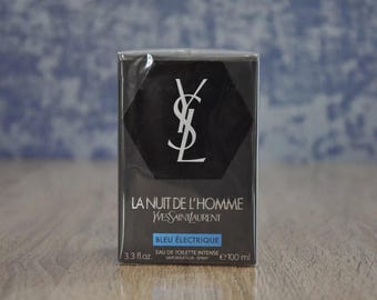 May include: A black and silver bottle of La Nuit de L'Homme Bleu Electrique cologne by Yves Saint Laurent. The bottle is 3.3 fl. oz. and contains Eau de Toilette Intense.