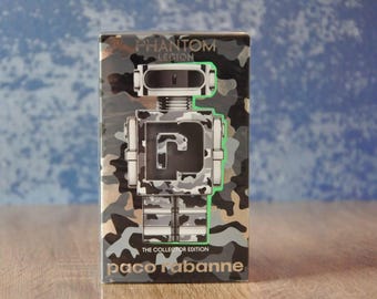 May include: A rectangular box with a camouflage robot design. The box features the text "PHANTOM LEGION" at the top and "THE COLLECTOR EDITION" and "paco rabanne" at the bottom. The robot design has a green outline.
