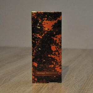 May include: A box with a black and orange abstract pattern. The text "Montagut International" is printed in gold on the front of the box.