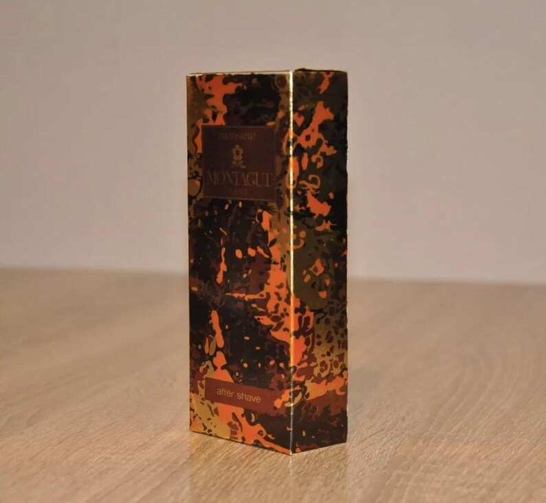 May include: A gold and black aftershave bottle with a camouflage pattern and the text "MONTIQUE" on the front.