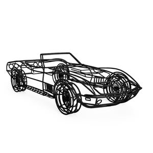 May include: Black wireframe sculpture of a classic convertible car. The sculpture features detailed wheels, a sleek body, and a minimalist design. The car's dimensions are approximately 16 inches long, 6 inches wide, and 4 inches high.