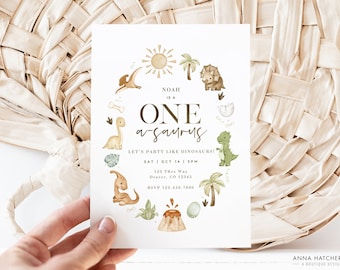 May include: A white invitation card with a green, brown, and yellow dinosaur theme. The text reads "Noah is a One-a-saurus! Let's party like dinosaurs! Sat | Oct 14 | 3PM 123 Tres Way Denver, CO 12345 RSVP 123.456.7890"