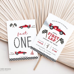 May include: A red and white race car themed first birthday party invitation with the text "Jaxx's First Lap Around the Track" and details for the party. The invitation features a red race car with a checkered flag and smoke coming from the exhaust.