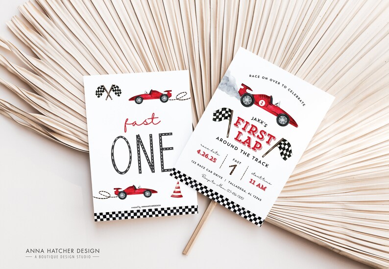 May include: A red and white race car themed first birthday party invitation with the text "Jaxx's First Lap Around the Track" and details for the party. The invitation features a red race car with a checkered flag and smoke coming from the exhaust.