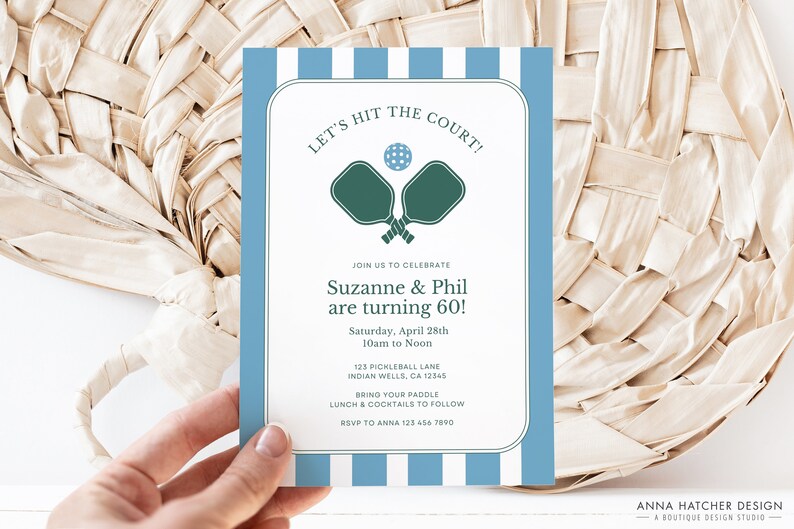 May include: A blue and white striped invitation card with the text "Let's Hit the Court!" and a graphic of two pickleball paddles. The invitation is for Suzanne and Phil's 60th birthday party, which will be held on Saturday, April 28th from 10am to noon at 123 Pickleball Lane, Indian Wells, CA 12345. Guests are asked to bring their paddle and RSVP to Anna at 123 456 7890.