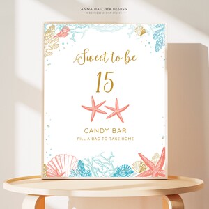 May include: A framed sign with a white background features the text "Sweet to be 15" in gold script, with coral starfish and sea life illustrations. The words "CANDY BAR" and "FILL A BAG TO TAKE HOME" are also included.