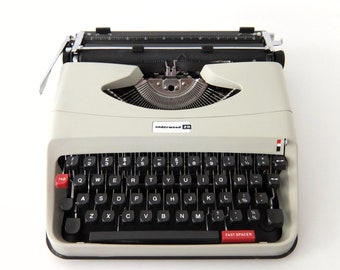 Beautifu Underwood 20 typewriter. Light grey color, 1970's QWERTY keyboard layout, new ink ribbon.