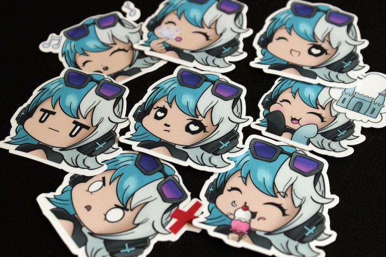 May include: A selection of anime-style stickers. Each sticker depicts a character with blue and white hair, wearing headphones and sunglasses, and displaying a different expression. Some stickers show the character blowing a bubble or eating ice cream.