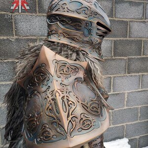 May include: A detailed, ornate, copper-colored helmet with intricate designs and a fur-lined collar. The helmet is part of a LARP costume.