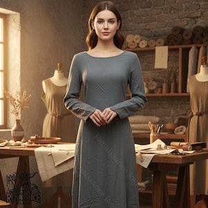 May include: A long-sleeved, gray dress with a round neckline. The dress is made of a soft fabric and has a simple, elegant design. The dress is part of a Renaissance-themed clothing collection.