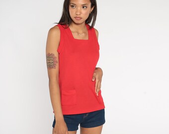 May include: A red sleeveless tank top with a square neckline and a single pocket on the front. The tank top is made of a ribbed fabric.