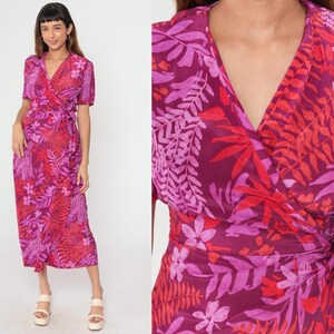 May include: A long, pink and red floral print wrap dress with short sleeves and a V-neckline.