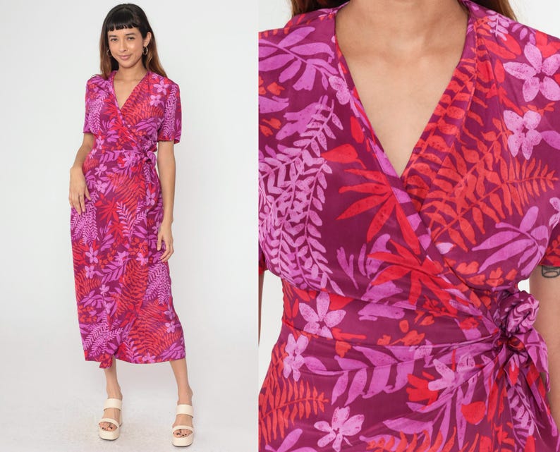 May include: A long, pink and red floral print wrap dress with short sleeves and a V-neckline.