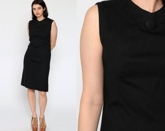 May include: A black sleeveless dress with a round neckline and a single button closure at the neck.