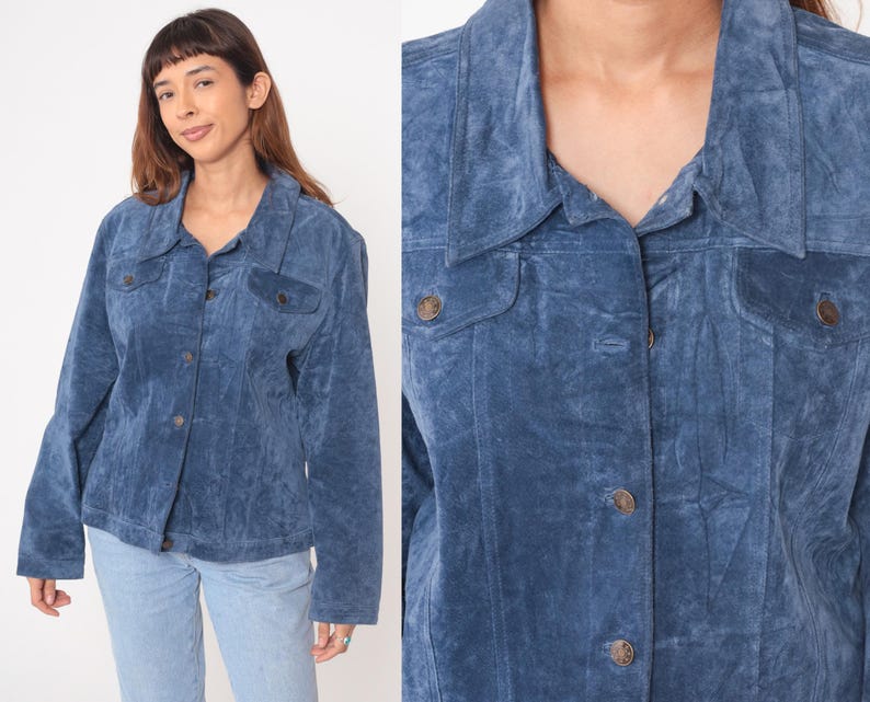 May include: A blue suede jacket with a button-up front, two chest pockets, and a collared neckline. The jacket has long sleeves and is a medium shade of blue. The buttons are a bronze color.