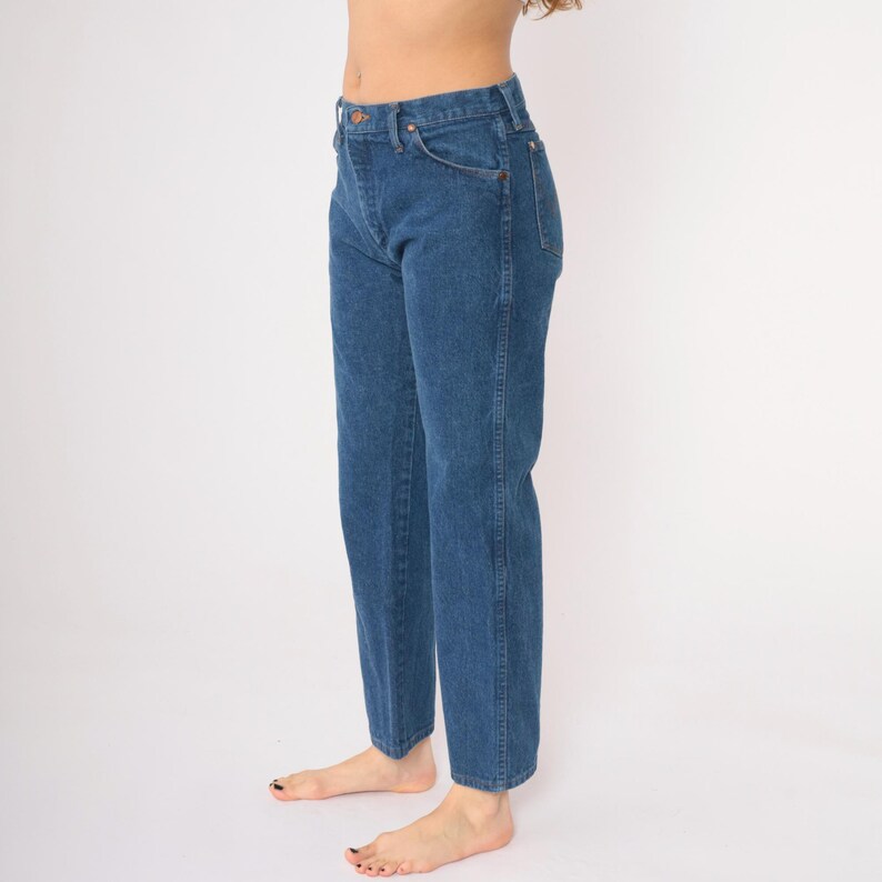 May include: A pair of blue denim jeans with a high waist and straight leg.