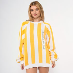 May include: Yellow and white striped sweatshirt with the text "Sun Houston State" printed on the side.