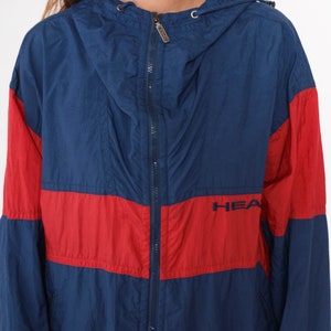 May include: A blue and red windbreaker jacket with a zipper closure and the word "HEATHER" embroidered on the front.
