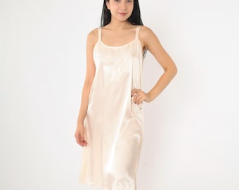May include: A white satin slip dress with thin straps.