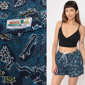 May include: Blue and white patterned swim shorts with a 'Beach Bum Philippines' label. The shorts feature a variety of animal designs, including turtles, crocodiles, and fish.