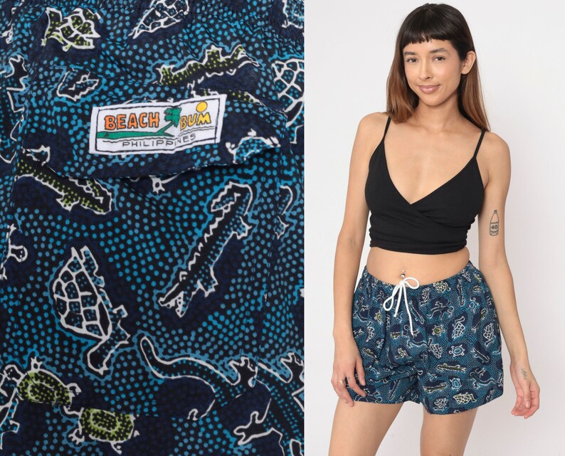 May include: Blue and white patterned swim shorts with a 'Beach Bum Philippines' label. The shorts feature a variety of animal designs, including turtles, crocodiles, and fish.