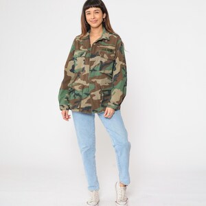 May include: A camouflage jacket with a button-up front and two large pockets. The jacket has the text "U.S. ARMY" embroidered on the left chest.
