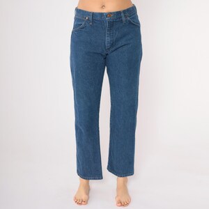May include: A pair of blue denim jeans with a straight leg fit.