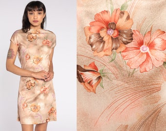 May include: A short, sleeveless dress with a brown and orange floral print on a beige background. The dress has a scoop neck and a fitted silhouette.