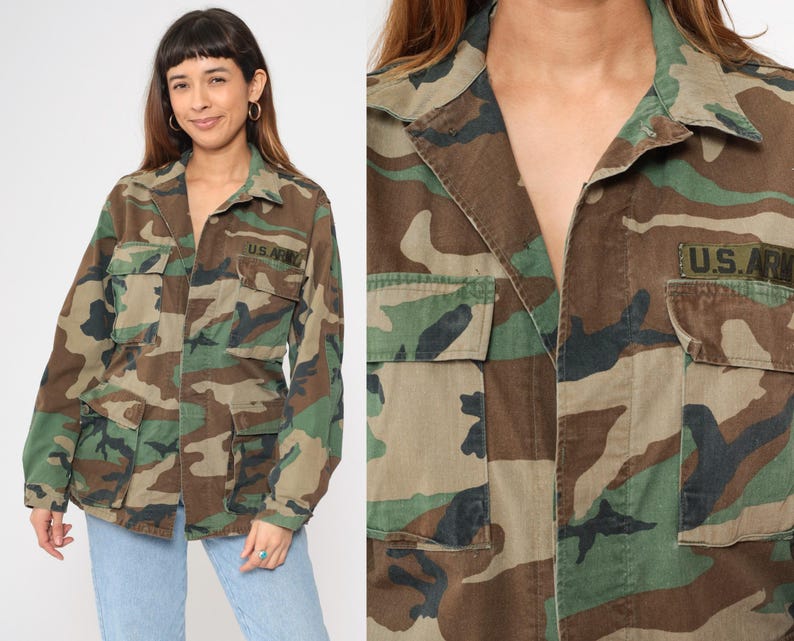 May include: A green, brown, and black camouflage jacket with a button closure and two flap pockets. The jacket has a patch on the right side that says "U.S. ARMY".