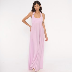 May include: A floor-length, light lavender maxi dress featuring a sleeveless halter neckline with a gathered bodice. The garment has a fitted waistline that transitions into a long, flowing skirt that reaches the floor, creating a simple silhouette.