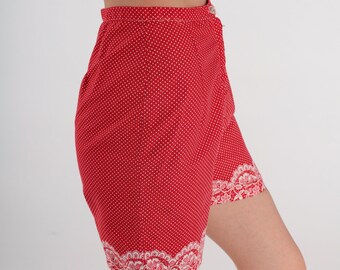 May include: Red and white polka dot shorts with white lace trim around the bottom.