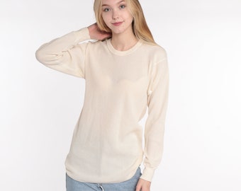 May include: A white long-sleeved thermal shirt with a crew neck.
