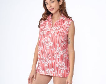 May include: A sleeveless red and white striped shirt with a floral pattern. The shirt has a collar and a button-up front.