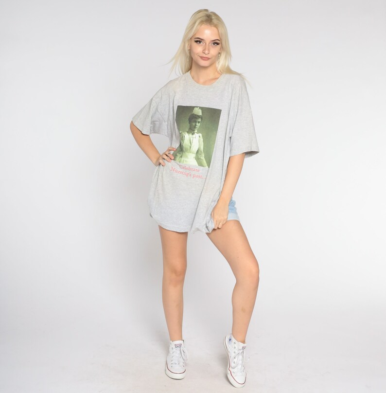 May include: A gray t-shirt with a graphic of a woman in a nurse's uniform. The text "Debbie Nurse's Party" is printed below the image.
