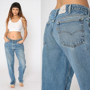 May include: A pair of light blue denim jeans with a high waist and a straight leg. The jeans have a faded look and are made of a soft, comfortable fabric.