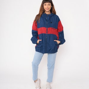 May include: A blue and red windbreaker jacket with a zipper closure and a hood. The jacket has a logo that says "H-STREET" on the front.