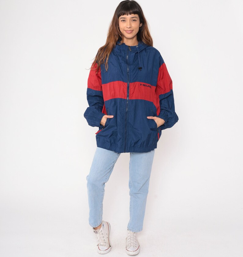 May include: A blue and red windbreaker jacket with a zipper closure and a hood. The jacket has a logo that says "H-STREET" on the front.