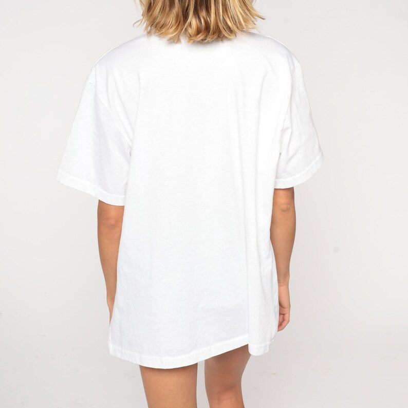 May include: A white oversized t-shirt with short sleeves.
