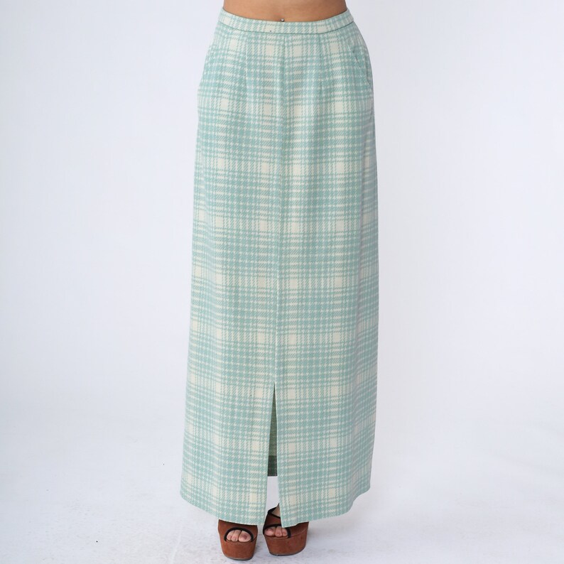 May include: A long, light blue skirt with a white and light blue plaid pattern. The skirt has a front slit and a high waist.