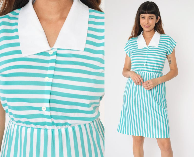 May include: A short-sleeved, turquoise and white striped dress with a white collar and button closure. The dress has a fitted bodice and a slightly flared skirt.