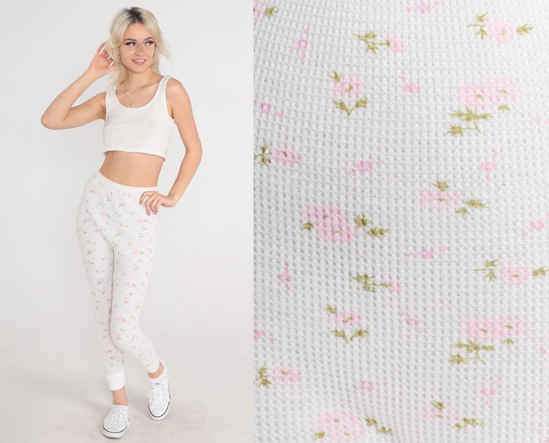 May include: White thermal leggings with a small pink floral pattern.